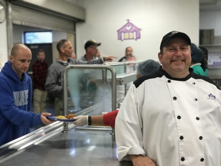 Gary working behind the kitchen at the program.