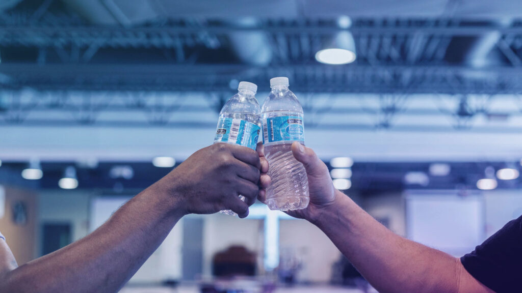 people drinking water from water bottles