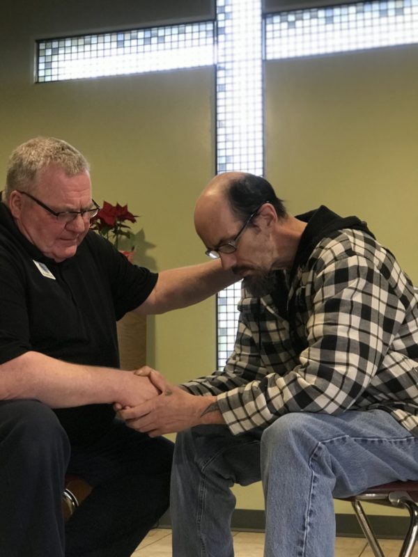 William praying at the program.