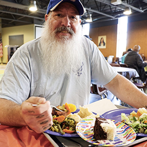 Photo of Alfred, eating a meal at the mission.