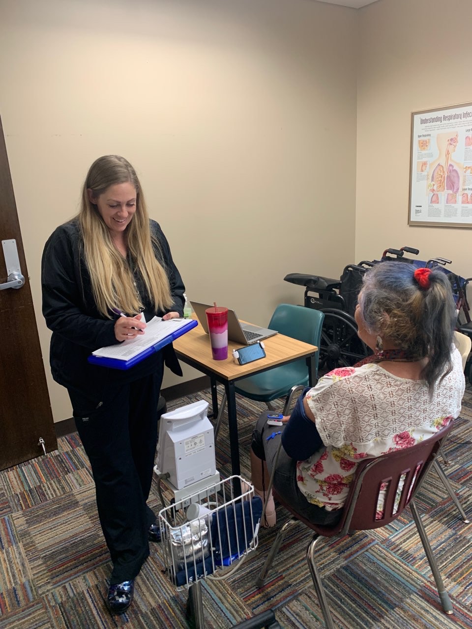 A volunteer handing out healthcare supplies to guest.