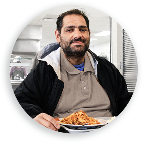 This is an image of a gentleman having a meal at Open Door Mission.